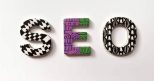 A model of the word "SEO" coloured with tribal markings