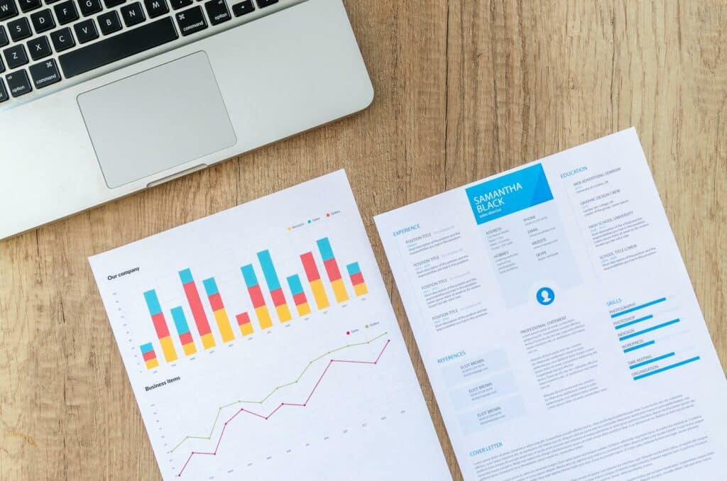 What is a Marketing Plan? | How to Create and Implement a Winning Plan 6 Two White Printer Papers Near Macbook on Brown Surface