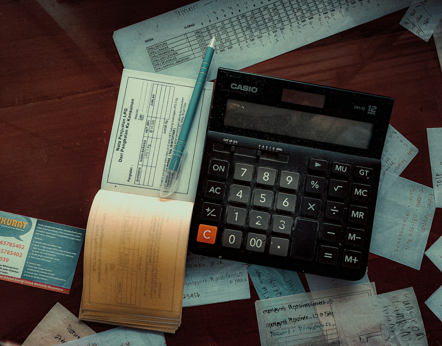 a calculator sitting on top of a wooden table small business bookkeeping