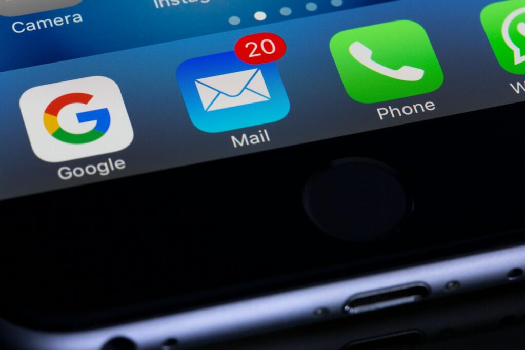 Best Email Hosting for Small Business Success in 2025 7 A close-up photo of a smartphone displaying popular apps like Google and Mail.