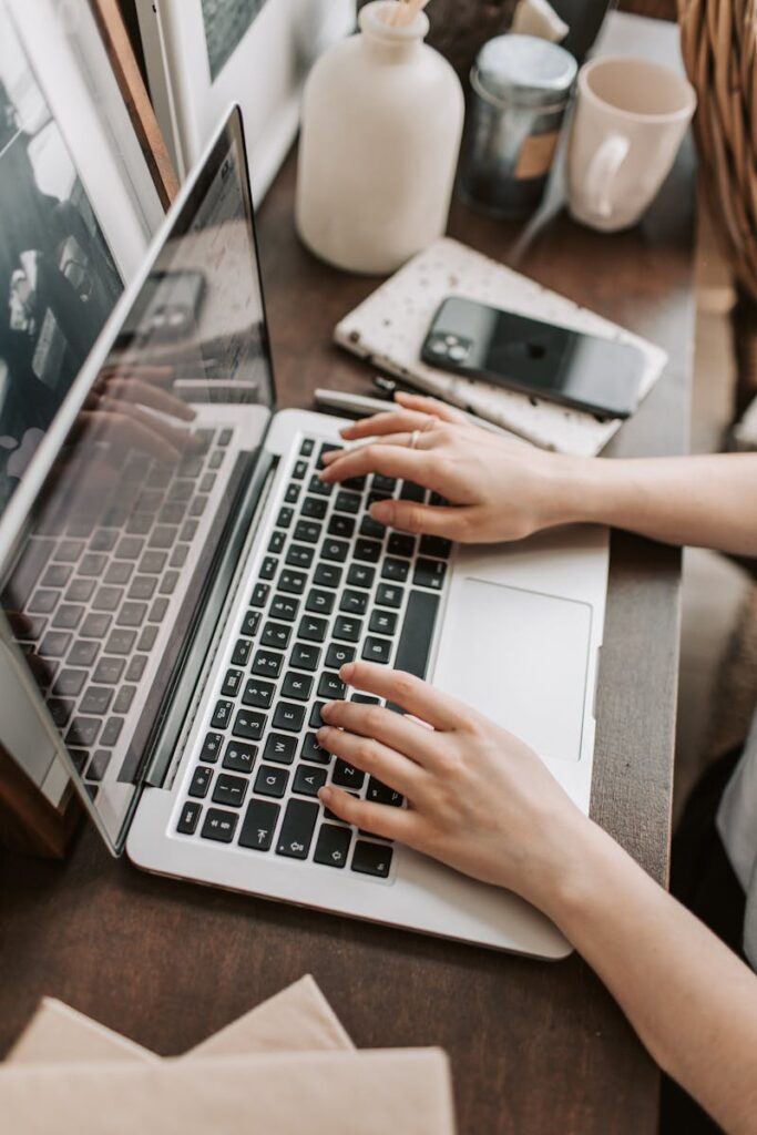 The Power of SEO Services for Small Business Success | Priceless Consulting Can Be Your Digital Marketing Solutions 3 From above of unrecognizable woman sitting at table and typing on keyboard of computer during remote work in modern workspace