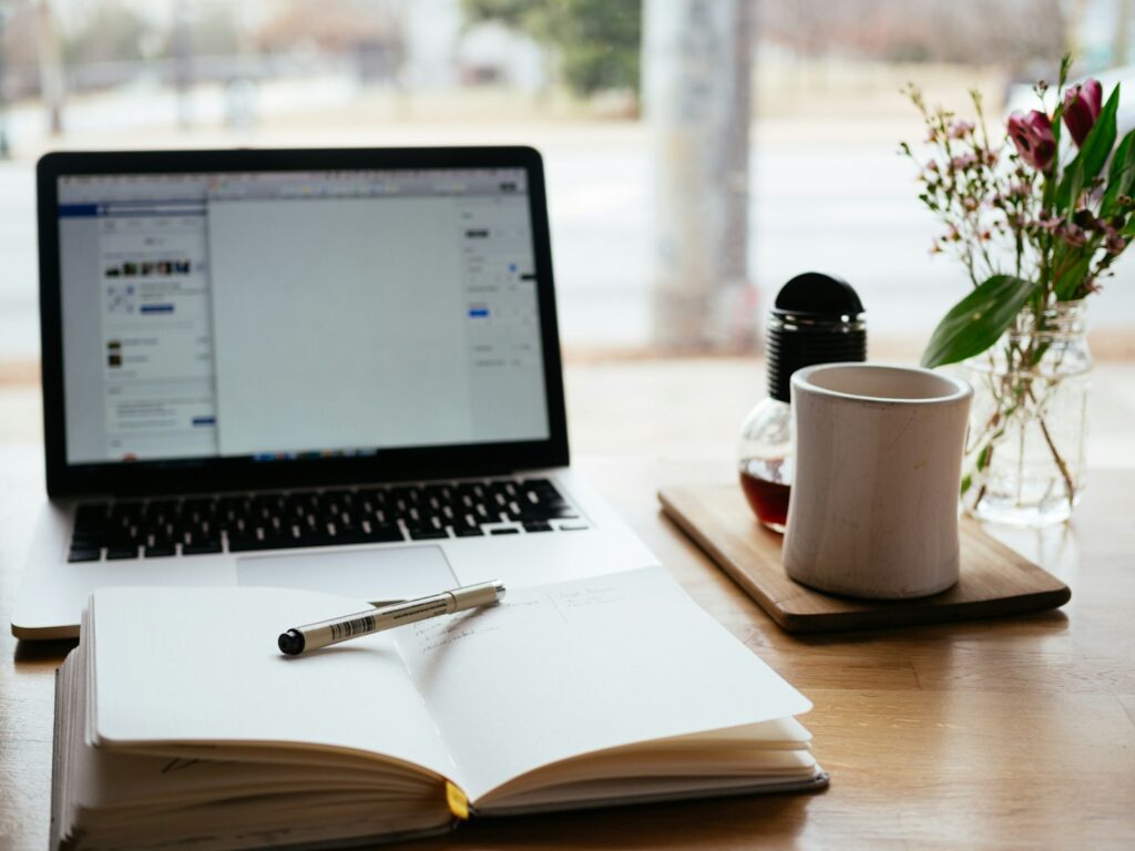 Choosing the Right Small Business Marketing Agency for Your Growth 4 MacBook Pro near white open book