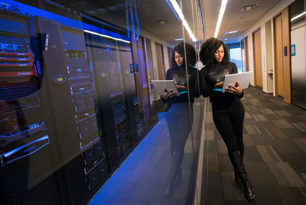 Best Web Hosting for Small Business and Why Kinsta is the Top Choice 3 woman in black top using Surface laptop