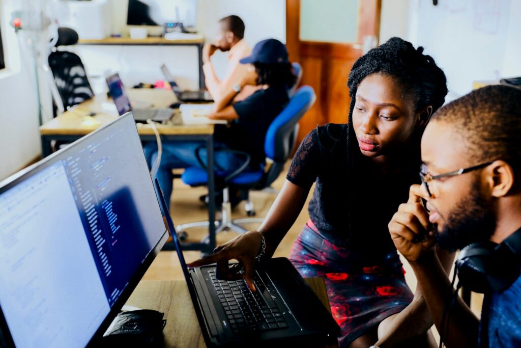 Web Design Services for Small Business Success with Priceless Consulting 28 woman and man sitting in front of monitor