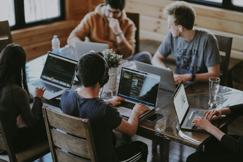 Mastering Ecommerce Website Development: A Practical Guide for Success 3 group of people using laptop computer