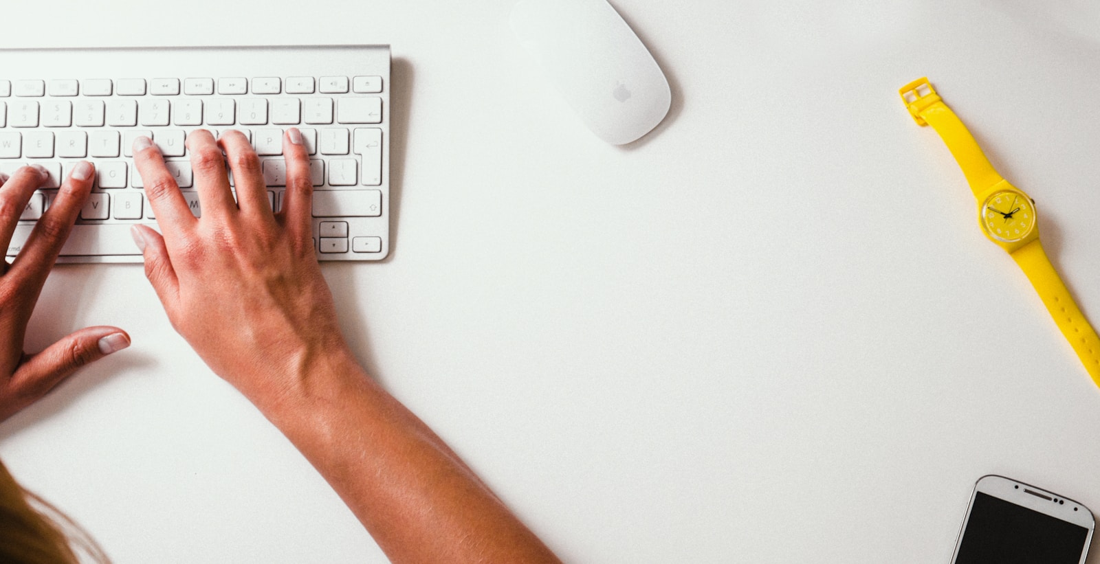 person typing on Apple Cordless Keyboard seo services for small business