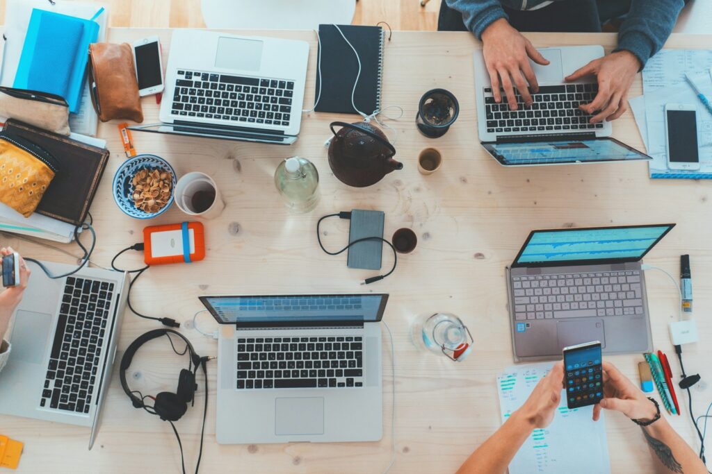 The Ultimate Guide on How to Check Website Ranking Effectively 4 people sitting down near table with assorted laptop computers