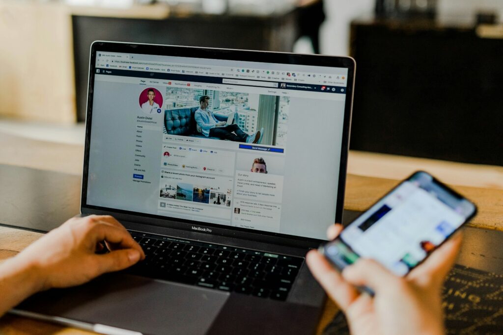 Choosing the Right Small Business Marketing Agency for Your Growth 6 person using both laptop and smartphone