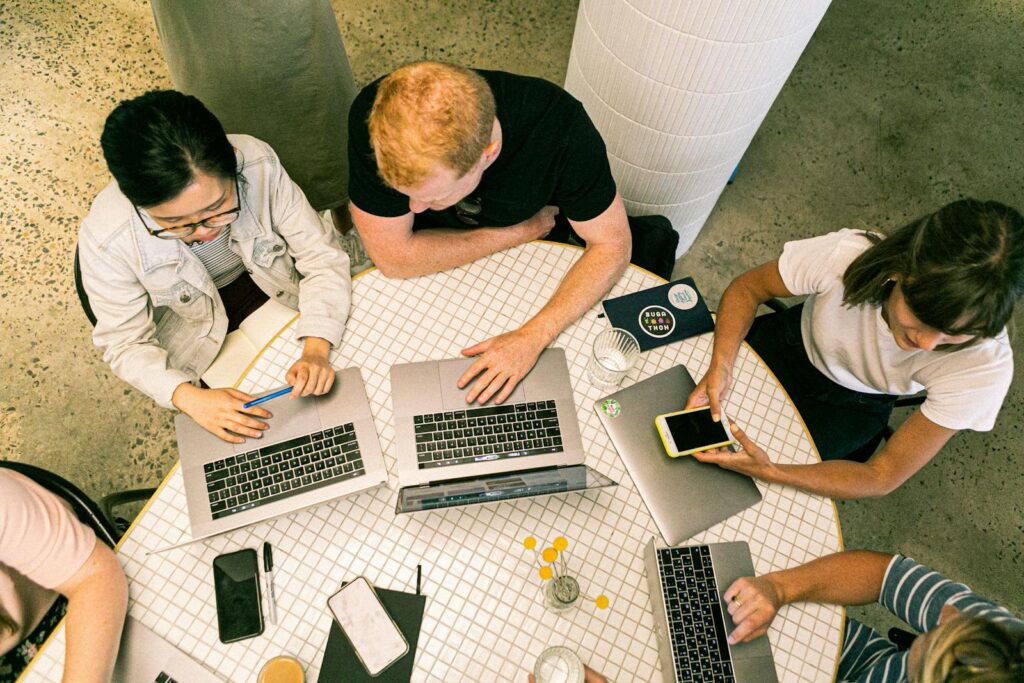 Guide to Marketing Consultants and Priceless Consulting 9 Top view of diverse team collaboratively working in a modern office setting.