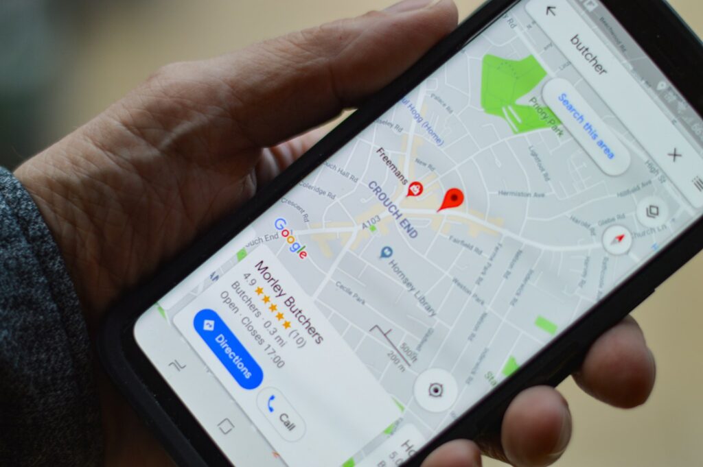 How to Delete a Google Review 3 person holding black smartphone
