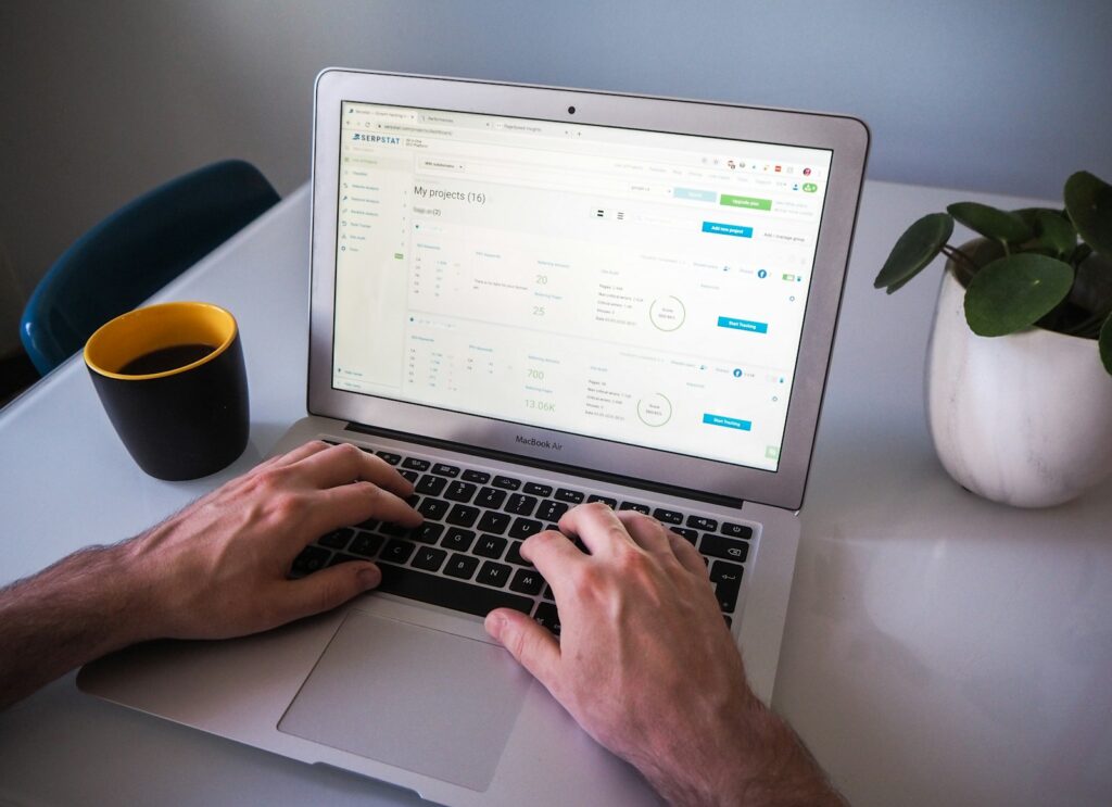 Search Engine Marketing Consultant: Everything You Need To Know 3 person using macbook air on white table