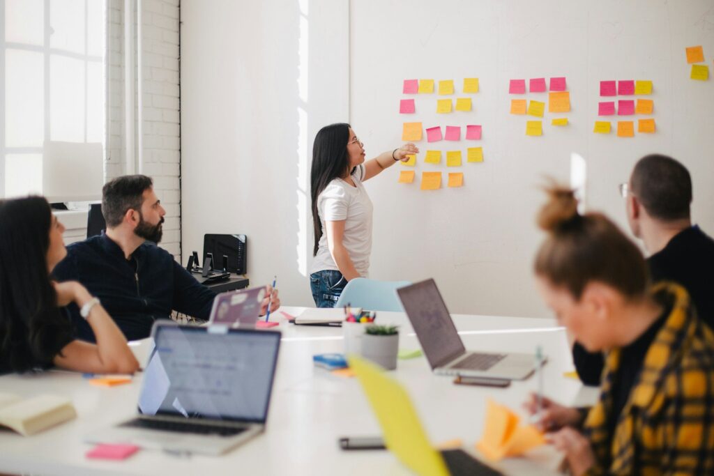 Guide to Marketing Consultants and Priceless Consulting 3 woman placing sticky notes on wall