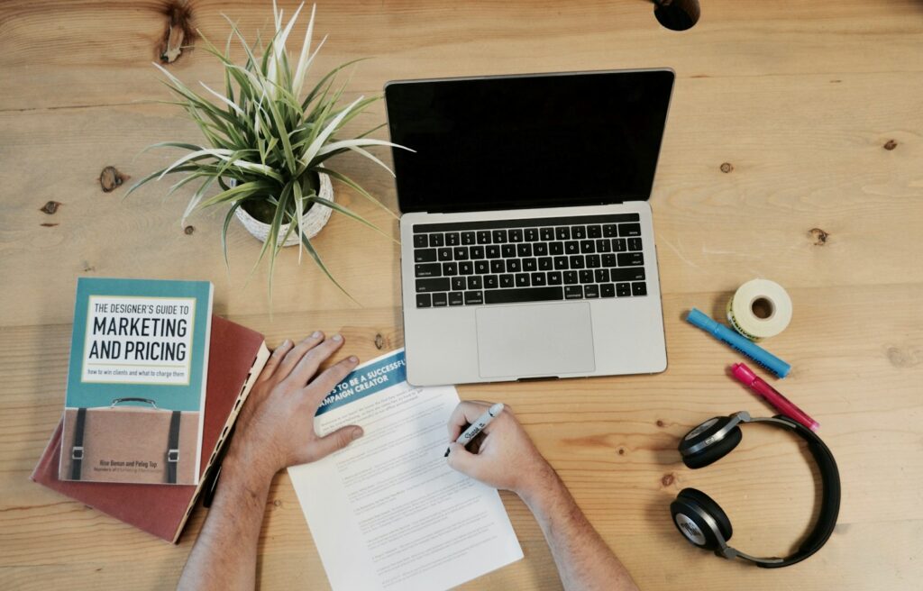 Digital Marketing Services for Small Business | Use Priceless Consulting As Your Marketing Strategy 2 MacBook Pro near headphones