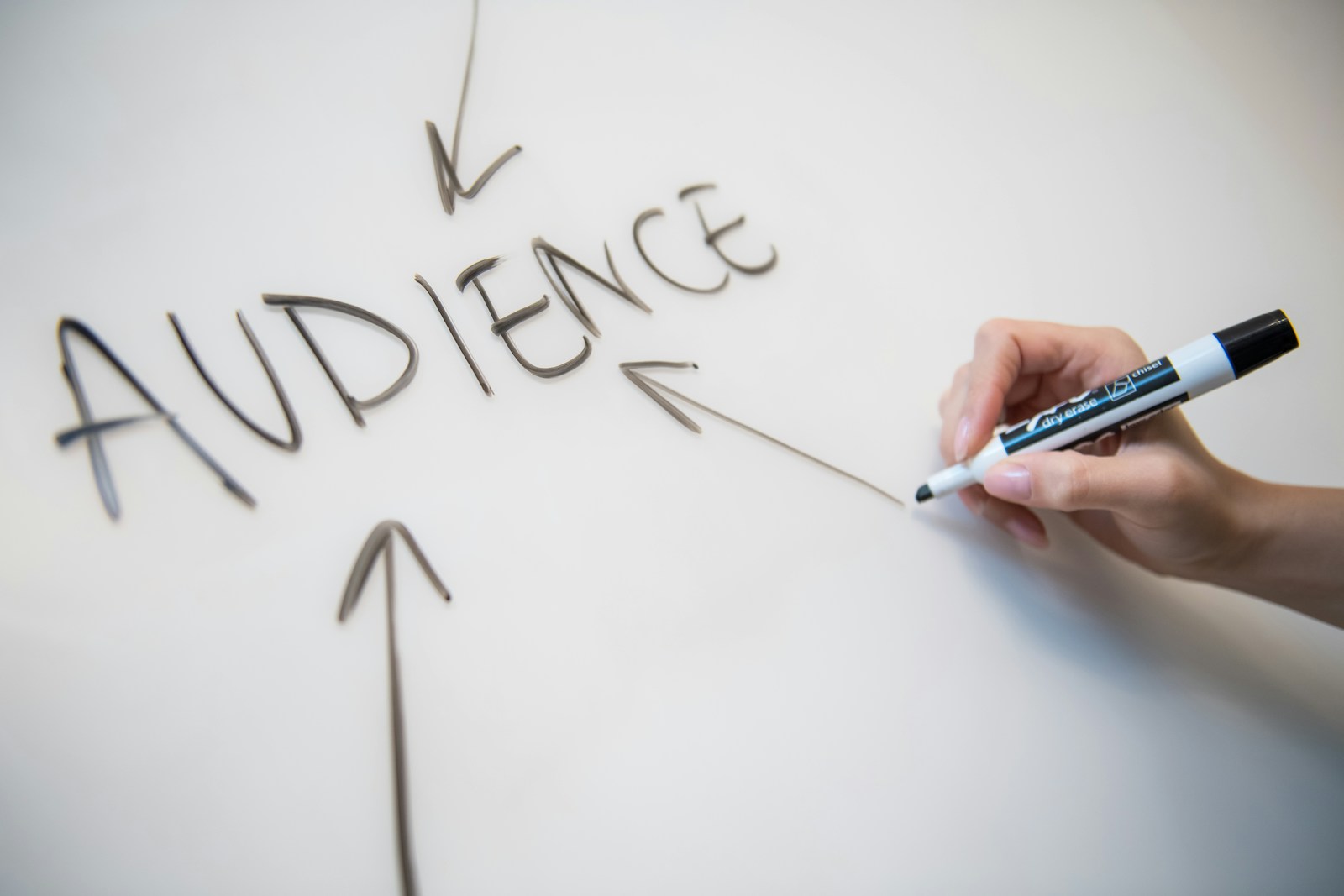 person writing on white paper marketing consultants