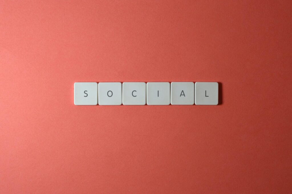 Social Media Optimization: Your Complete Guide to SMO Success 12 Close-up of the word 'SOCIAL' formed with tiles on a red surface, offering copyspace.