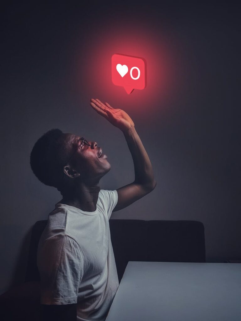 Decoding Social Media Marketing Packages: Your Complete Guide 6 A man sits indoors reaching towards a glowing social media notification icon.