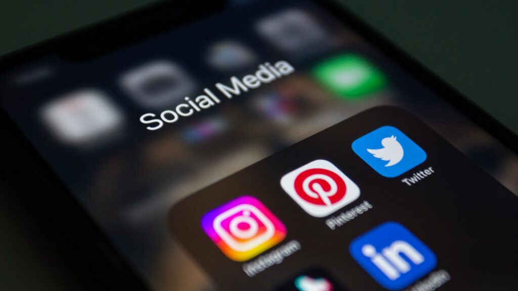 The Complete Social Media Audit Guide for Small Businesses 3 a close up of a cell phone with social media icons on it