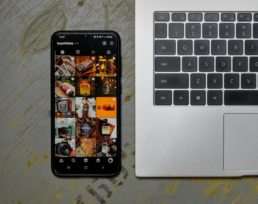 Best Time to Post on Social Media for Maximum Engagement 5 an open laptop computer sitting next to a cell phone