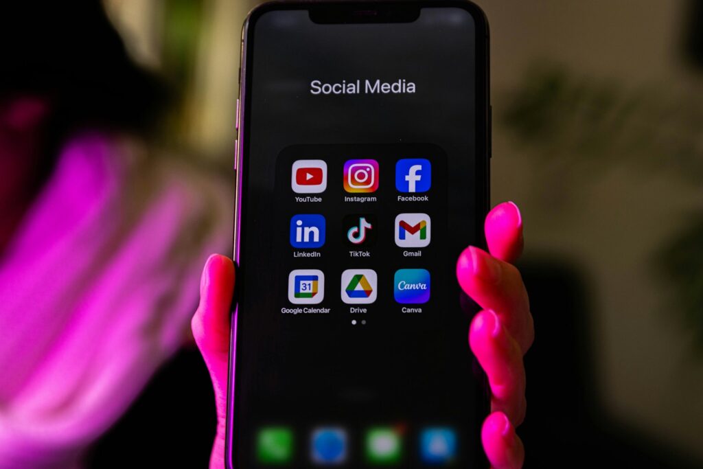 Social Media Consultant: Your Complete Guide to Success 4 A smartphone displays social media app icons.