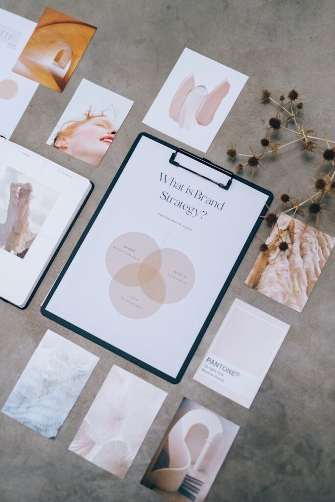 Branding Strategies: How to Build a Memorable and Profitable Brand 3 Aesthetic flat lay of branding and design documents on textured surface.