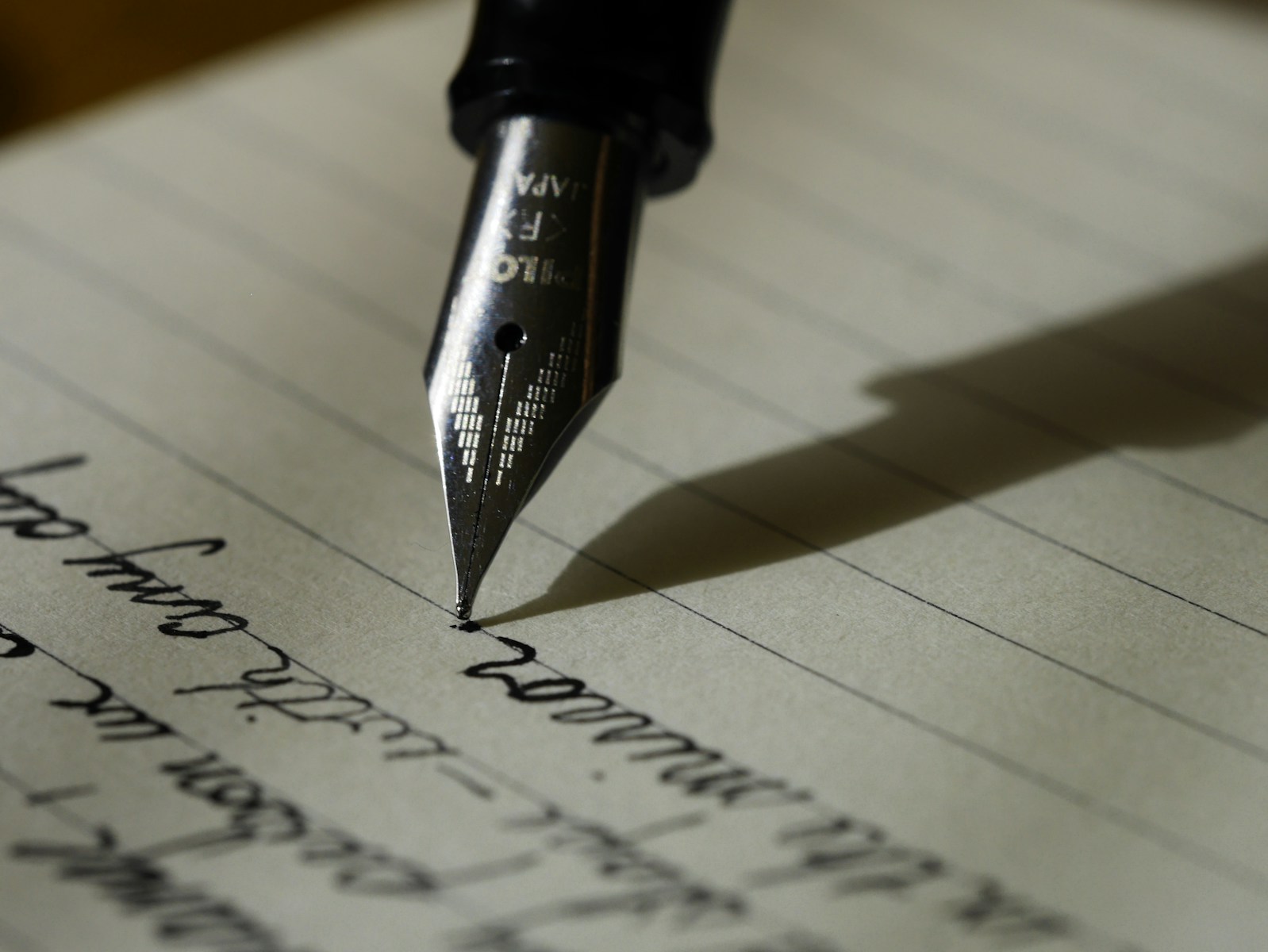fountain pen on black lined paper (Law Firm Web Design) | Tailored Sites That Build Trust & Credibility